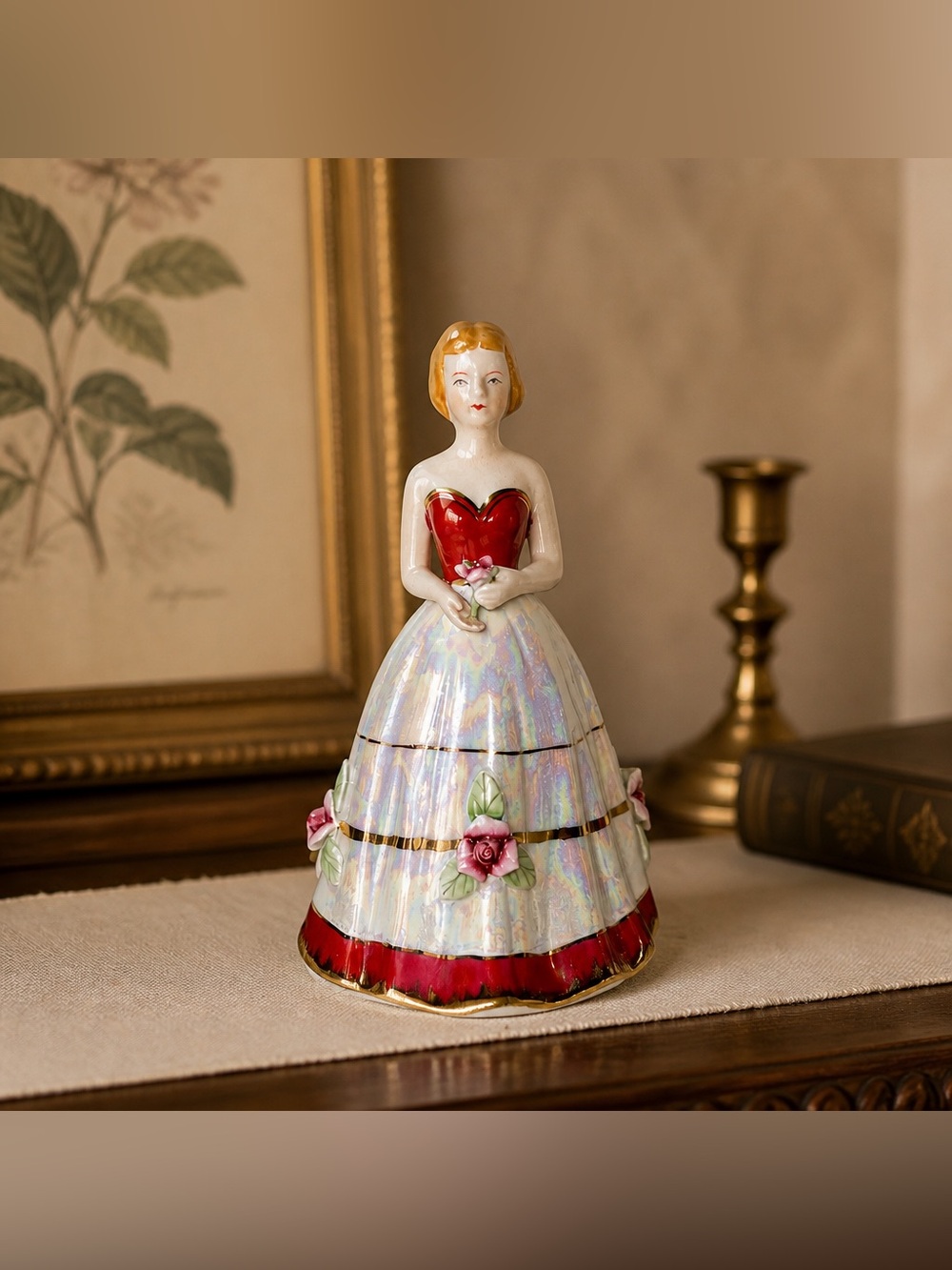 Porcelain Victorian style figurine dressed in an opalescent red and white Dress